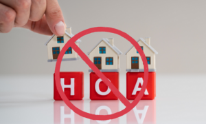 Houses on top of letters HOA with a no symbol on top